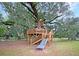 Wooden treehouse playground with slide and multiple levels at 522 Oak View Way, Summerville, SC 29483