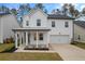 Two-story white house with gray roof, front porch, and two-car garage at 530 Richfield Way, Summerville, SC 29486