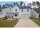 Two-story white house with gray roof, front porch, and two-car garage at 530 Richfield Way, Summerville, SC 29486