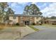 Front view of a brick triplex with a green lawn at 7780 Wayfield Cir, North Charleston, SC 29418