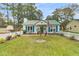 Quaint white house with green roof and yard at 104 Tanager St, Summerville, SC 29483