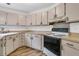 Galley kitchen with light beige cabinets and black appliances at 104 Tanager St, Summerville, SC 29483