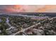 Aerial view of neighborhood near water at sunset at 105 Folly Road Blvd, Charleston, SC 29407