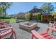 Brick firepit and red chairs in a gravel backyard patio at 105 Folly Road Blvd, Charleston, SC 29407