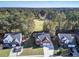 Aerial view of a two-story brick home with a two-car garage, situated on a golf course at 111 Dasharon Ln, Goose Creek, SC 29445