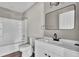 Modern bathroom with white vanity, black fixtures, and a bathtub at 1243 Pineville Cir, Pineville, SC 29468