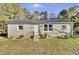 Brick ranch home with a metal roof and fenced yard at 1243 Pineville Cir, Pineville, SC 29468