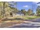 Ranch home with metal roof, fenced yard, and mature trees at 1243 Pineville Cir, Pineville, SC 29468
