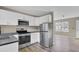 Modern kitchen with white cabinets, stainless steel appliances, and dark countertops at 1243 Pineville Cir, Pineville, SC 29468