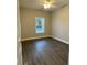 Bright bedroom with dark hardwood floors and a large window at 175 Dandelion Ct, Round O, SC 29474