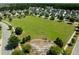 Aerial view of a residential neighborhood with a large green space, playground, and gazebo at 192 Lindera Preserve Blvd, Summerville, SC 29486