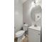 Small bathroom with white vanity, toilet, and round mirror at 192 Lindera Preserve Blvd, Summerville, SC 29486