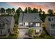 Two-story brick home with gray roof, palm trees, and a large driveway at 192 Lindera Preserve Blvd, Summerville, SC 29486