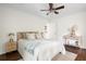 Cozy bedroom with wooden headboard, ceiling fan and hardwood floors at 2560 Mona Ave, Charleston, SC 29414