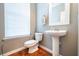 Small bathroom with pedestal sink, toilet and large window with blinds at 3532 Claremont St, Mount Pleasant, SC 29466