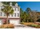 Two-story townhome with a two-car garage and nicely landscaped front yard at 3532 Claremont St, Mount Pleasant, SC 29466