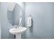 Small bathroom with pedestal sink, oval mirror, and light blue walls at 4004 Radcliffe Pl Dr # K-1, Charleston, SC 29414