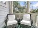 Cozy screened porch with wicker chairs and a side table at 4028 Bridle Trail Dr, Seabrook Island, SC 29455