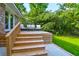 Elevated wooden deck with stairs and seating area at 4627 Shark Hole Rd, Meggett, SC 29449