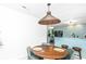 Modern dining area with a round wooden table and four green chairs, next to kitchen at 733 Gilmore Ct, Charleston, SC 29412