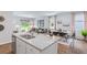 Kitchen island with granite countertops, stainless steel sink, and white cabinets at 826 Lilyford Ln, Summerville, SC 29486