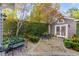 Brick courtyard with seating area, lush greenery, and access to studio at 99 King St, Charleston, SC 29401