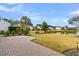 Brick patio overlooks pond and neighboring homes at 109 Billowing Sails St, Summerville, SC 29486