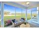 Relaxing screened porch overlooking a pond and grassy landscape, furnished with seating at 149 Winding Grove Ln, Moncks Corner, SC 29461