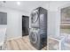 Bright laundry room with stacked washer and dryer and additional storage at 2060 Green Park Ave, Charleston, SC 29414