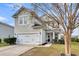 Two-story house with gray siding, white garage door, and landscaping at 223 Laurel Crest Way, Summerville, SC 29486