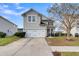 Two-story house with a gray exterior, white garage door, and landscaped yard at 223 Laurel Crest Way, Summerville, SC 29486