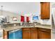 Kitchen boasts granite countertops, stainless steel dishwasher and view to Gathering room at 223 Laurel Crest Way, Summerville, SC 29486