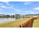Community pond with houses reflected in the water under a bright sky at 223 Laurel Crest Way, Summerville, SC 29486