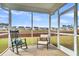 Screened porch with rocking chairs, offering a relaxing outdoor seating area at 223 Laurel Crest Way, Summerville, SC 29486
