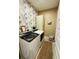 Laundry room with washer, dryer, and stylish floral wallpaper at 3105 Sturbridge Rd, Mount Pleasant, SC 29466