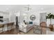 Open concept living room with light and airy feel, featuring a comfortable sofa and large windows at 572 Richfield Way Way, Summerville, SC 29486