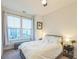 Bright bedroom with two windows, plush bedding, and a nightstand at 823 Recess Point Dr, Moncks Corner, SC 29461