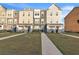 Three-story townhouses with neutral siding, landscaping, and paved walkways at 823 Recess Point Dr, Moncks Corner, SC 29461