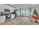 Open concept kitchen with white cabinets, stainless steel appliances, and a breakfast nook at 823 Recess Point Dr, Moncks Corner, SC 29461