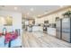 Open concept kitchen with white cabinets, granite countertops, and stainless steel appliances at 823 Recess Point Dr, Moncks Corner, SC 29461