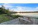Wooden dock with a picnic table overlooking a tranquil lake at 823 Recess Point Dr, Moncks Corner, SC 29461