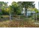 House exterior with a metal gate and tree-lined yard at 109 Beacon Ave, Moncks Corner, SC 29461