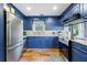 Updated kitchen with blue cabinets, granite countertops, and stainless steel appliances at 109 Beacon Ave, Moncks Corner, SC 29461
