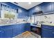 Updated kitchen with blue cabinets, granite countertops, and stainless steel appliances at 109 Beacon Ave, Moncks Corner, SC 29461