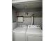 Stackable washer and dryer in a well-lit laundry room at 114 Lewisfield Dr, North Charleston, SC 29418