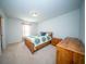 Cozy bedroom with a queen-size bed and wooden furniture at 117 Guinness Ln, Moncks Corner, SC 29461