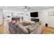 Open living room with hardwood floors, sectional sofa, and fireplace at 1592 Boston Grill Road, Mount Pleasant, SC 29466