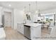 Open kitchen features a large island, stainless steel appliances, and white cabinetry at 185 Surf Bird Rd # 506P, Summerville, SC 29486