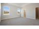 Spacious bedroom with plush carpet, two windows, and en-suite bathroom at 300 Claret Cup Way, Charleston, SC 29414