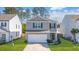 Gray siding two-story house with a white garage door and landscaping at 314 Black Birch Dr, Summerville, SC 29486